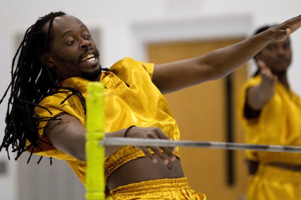 African Acrobats Zee Ali, a native of Kenya, reacts as he prepares to go under a limbo bar during a performance of African acrobatics on Friday, March 18, 2011, at Freedom Elementary in Cheyenne. James Brosher/staff